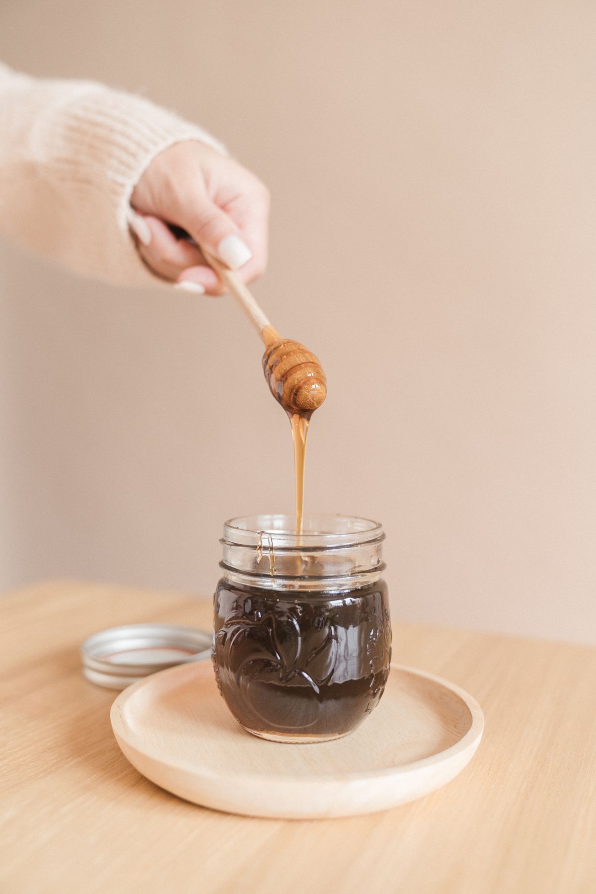 Raw honey being drizzled at a table